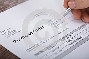 Person Filling A Purchase Order Form