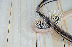 Close-up of person hand holding comb with loss hair