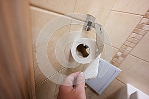 Close up of person hand using toilet paper