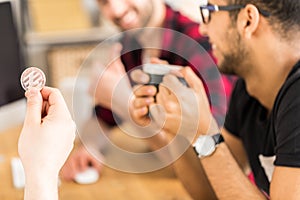 Close-up of person holding coin as a symbol of digital money during meeting of stockbrokers photo