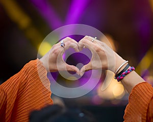 Close Up Of Person Making Heart Shaped Hand Gesture At Outdoor Summer Music Festival