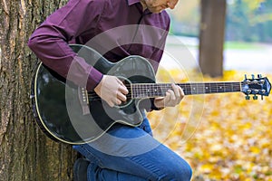 Close up person man`s hands playing acoustic guitar artist music