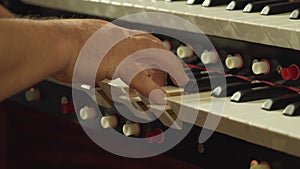 A close up of a person playing the church organ