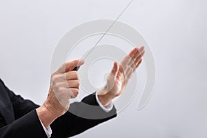 Person Directing With Conductors Baton photo