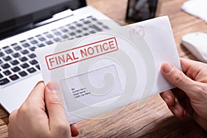 Person Holding Final Notice Envelope