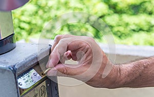 Close-up Of Person's Hand Inserting Ticket Into Parking Machine