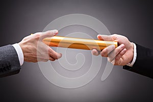 Person Passing Baton To Businessperson