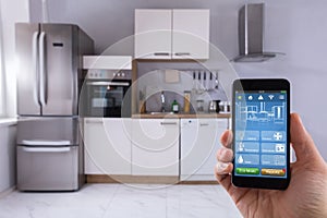 Person Using Smart Home System On Mobilephone