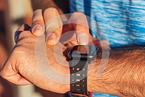 Close-up of a person`s hands using their smart watch to access their mobile phone from the app.Health, technology, sport,