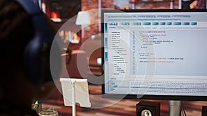 Close up of person using coding application to write and test code