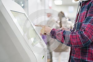 Close up person using touch screen panel in post office to recieve a package f photo
