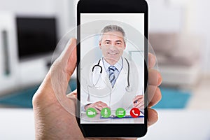 Person Video Conferencing With Doctor On Smartphone photo