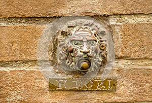 Close-up of a personified stone wall with a name plaque