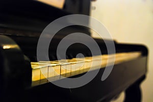 Close up perspective image of old piano keys with shallow depth of field