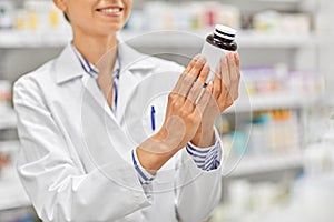 Close up of pharmacist with medicine at pharmacy