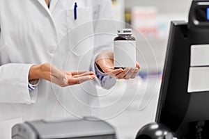 Close up of pharmacist with medicine at pharmacy