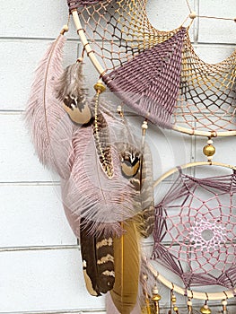 Close up pheasant feathers dream catcher bohemian wall hanging craft outdoors