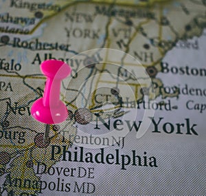 Close up of Philadelphia pin pointed on the world map with a pink pushpin