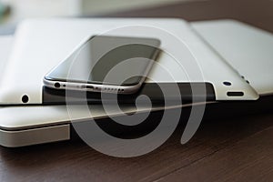 Close up phone on tablet and laptop