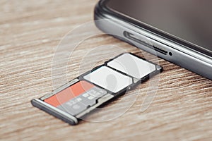 Close up of phone tray with two sim cards and a memory micro sd card