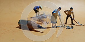 Close up Photo 2 man and 1 woman cleaning trash from pencil sharpener with negative space