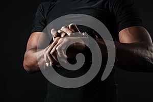 Close-up photo of african man in black t-shirt check out time at