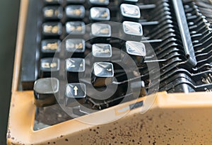 Close up photo of antique typewriter keys, focus on enter key