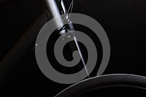 black bike frame, lefty fork and wheel on the black background photo
