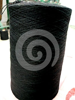 Close up photo of black threads in cones