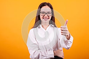 Close up photo of blurred girl showing thumb up in studio