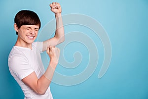 Close up photo of boy celebrating his victory at karate contests while isolated with blue background