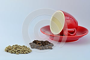 A close-up photo of a bright red espresso coffee cup, some green coffee beans and some roasted coffee beans on white background.