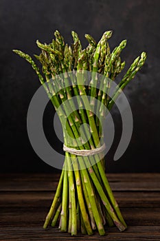 Close up photo Bunch of fresh green asparagus on wooden background