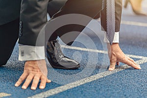 Close-up photo of businessman standing on race track