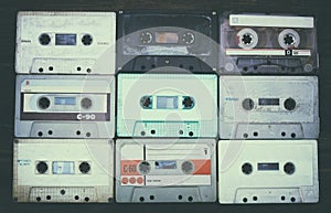 Close up photo of cassette tape over wooden table . top view. retro filtered