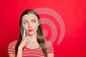 Close up photo of charming attractive thinking girl wearing red striped t-shirt pondering over something puzzling while