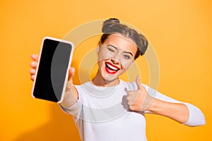 Close up photo of charming beautiful attractive lady offering suggesting recommending product raising her thumb up