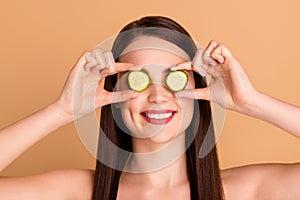 Close up photo of charming girlish lady close cove eyes with cucumber slice want effective natural skincare treatment