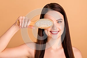 Close up photo of charming glamour girl hold hairbrush cover eye brush soft strong hair after new natural shampoo