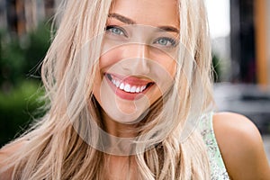 Close up photo of cheerful lovely cute young girl toothy smile bright shiny summer day isolated on blurred backdrop