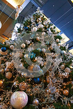 Close up photo of a Christmas tree with decorations, garlands and lights