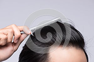 Close up photo of clean healthy man`s hair. Young man comb his h