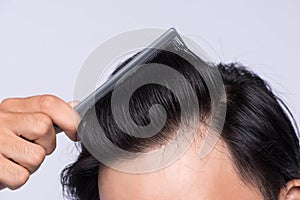 Close up photo of clean healthy man`s hair. Young man comb his h