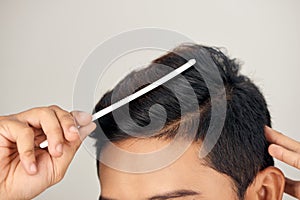 Close up photo of clean healthy man`s hair. Young man comb his hair