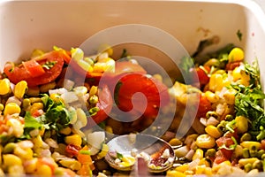Close up photo of continental vegetable corn salad in a bowl