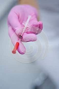 Close up photo of cosmetic injection in medical professional hand