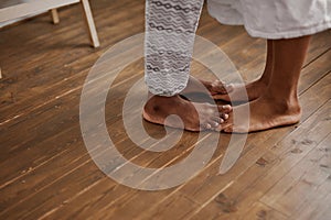 Close-up photo of couple feet on the floor