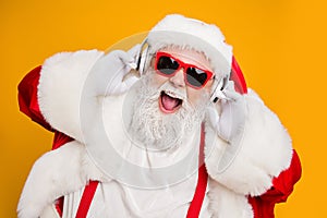 Close up photo of crazy funny santa claus listen music on modern headset celebrate christmas time noel party wear red