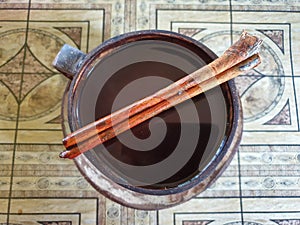 close up photo a cup of traditional coffee with palm sugar and cinnamons