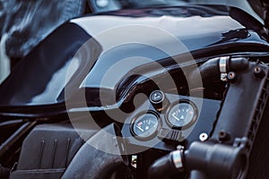 Close-up photo of a custom-made motorcycle fuel tank with sensors.